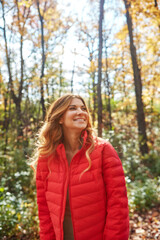 Thinking, smile and relax with woman in park for autumn holiday, peace and reflection. Travel, inspiration and fall season with female person outdoor for weekend break, happy and perspective