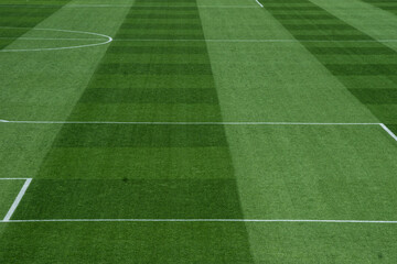 Obraz premium Well-Maintained Football Pitch with Striped Grass Pattern