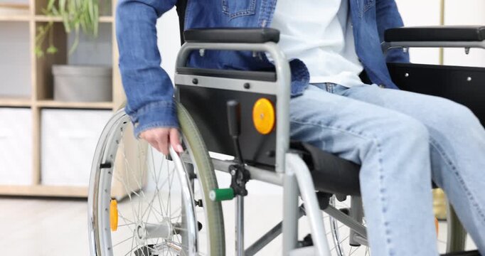Woman using wheelchair at home, closeup view