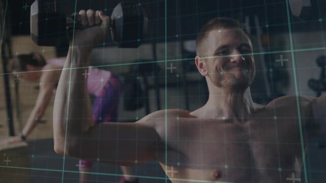 Shirtless man tensing, pressing dumbbells overhead for strength while grid overlay tracking motion