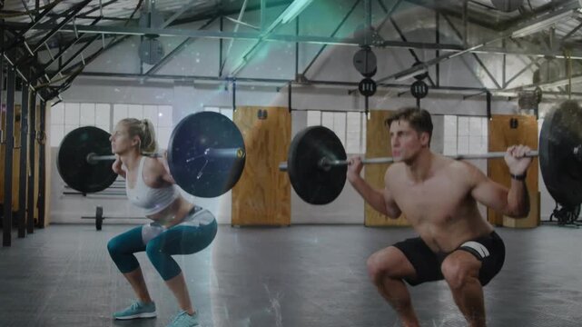Two partners starting set, performing barbell back squats for fitness with streaks marking rhythm