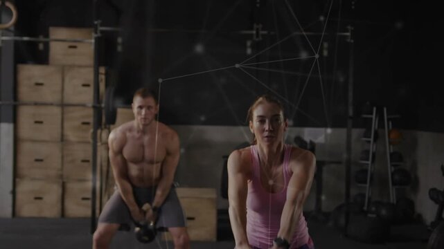 Woman leading kettlebell cadence, male partner mirroring in gym, overlay tracing swings for fitness
