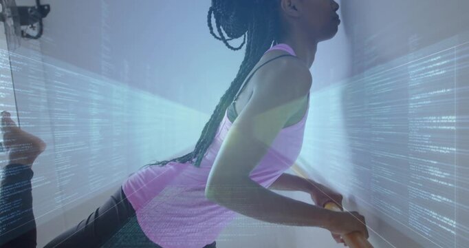 Vertical video: Woman holding barre hinging, lifting leg in arabesque for fitness amid holo lights