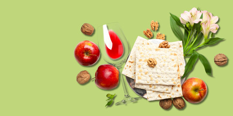 Fototapeta premium Matzah, apples, wine, walnuts, and flowers are arranged together