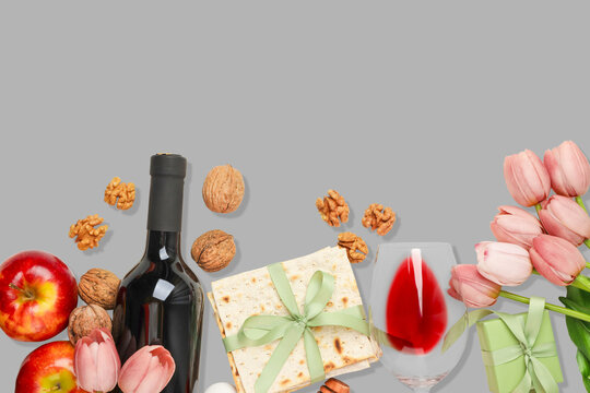 Table set with wine, matzah, apples, nuts, and flowers
