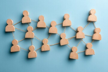 Obraz premium Interconnected Connections: A creative visual representation of social and professional connections, formed by a network of wooden figures interlinked with delicate threads.