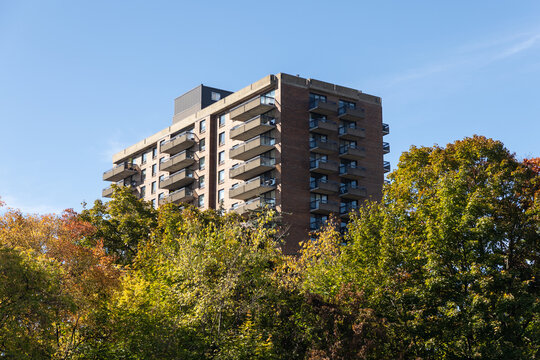Residential apartment building behind autumn trees in Ottawa, Canada