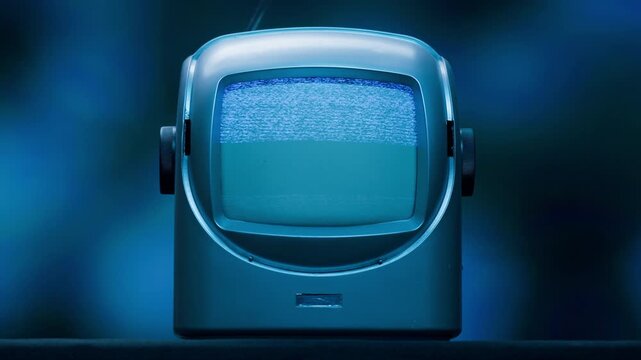 Retro TV, vintage television In a nostalgic setup, a retro TV displays grain on screen, scary halloween night device good for chroma key and green screen.