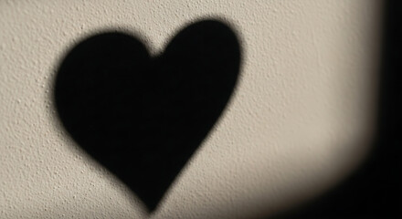 Obraz premium Soft shadow heart shape on textured wall minimalist love concept