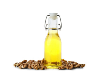 Tasty walnuts and bottle of oil on white background