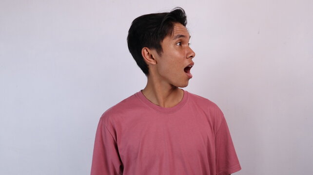 young asian man with surprised expression looking to the side