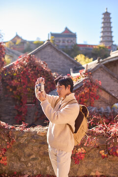 Happy man capturing memories on his trip