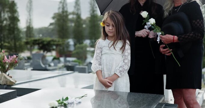 Grandparent, mom and girl in cemetery with flowers, support and remembrance in mourning. Emotional, women and child at gravestone with roses, family comfort and shared grief with memorial visit.