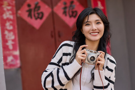Happy young woman travels in Beijing