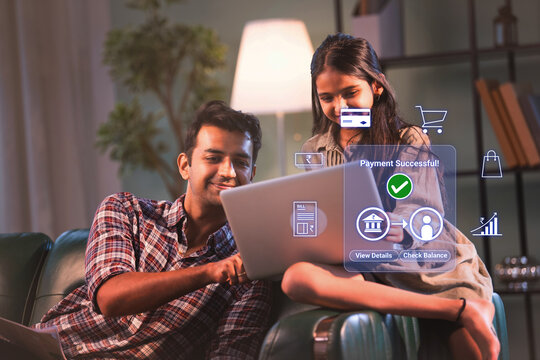 Indian young father and daughter doing online digital payment successful on laptop for household bills and savings to promote financial literacy and inclusion in digital india