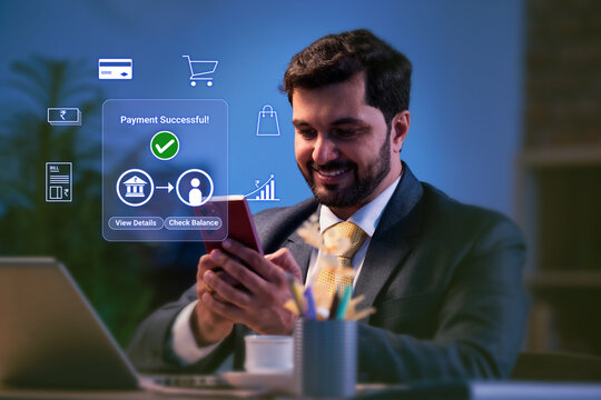 Indian handsome young businessman doing online digital payment successful on smartphone at office for digital india concept and financial inclusion while using mobile banking apps now