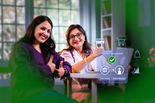 Indian young woman patient and senior lady doctor doing online digital payment successful at medical clinic for digital india concept and financial inclusion while using banking apps