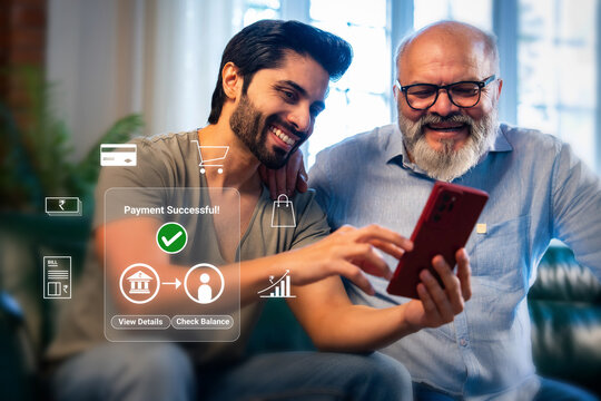 Indian handsome young man and senior father doing online digital payment successful on laptop at home