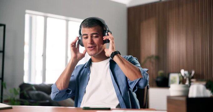 Headphones, dancing and man with phone in home office, streaming music and radio song for break. Audio tech, playlist and happy person singing to track with mobile, listening and moving to rhythm