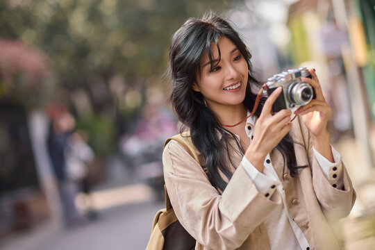 Happy young woman travels in Beijing