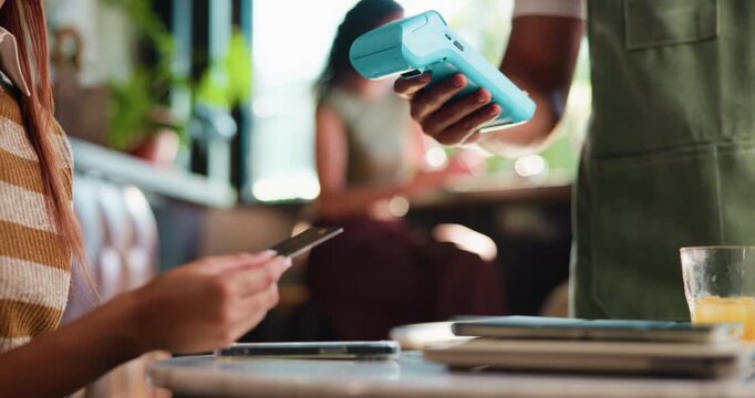 Payment, credit card or hands in cafe with machine, eft service or online transfer in pos system. People, customer or waiter with tech, cashless checkout or wireless transaction in electronic banking