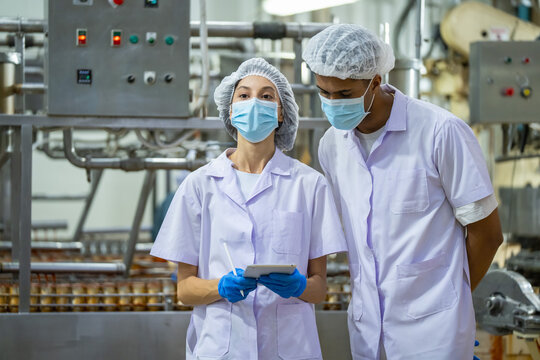 Quality control meeting in food processing plant industrial setting team collaboration professional environment