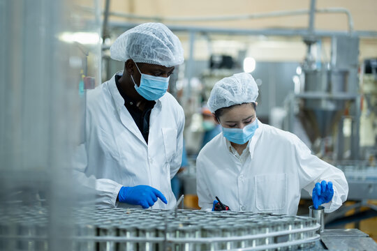 Laboratory quality control assessment pharmaceutical manufacturing facility professional interaction industrial environment collaborative viewpoint
