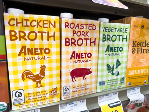 Aneto Natural Chicken Pork And Vegetable Broth Cartons Displayed On Grocery Store Shelf