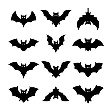 Collection of black bat silhouettes flying.