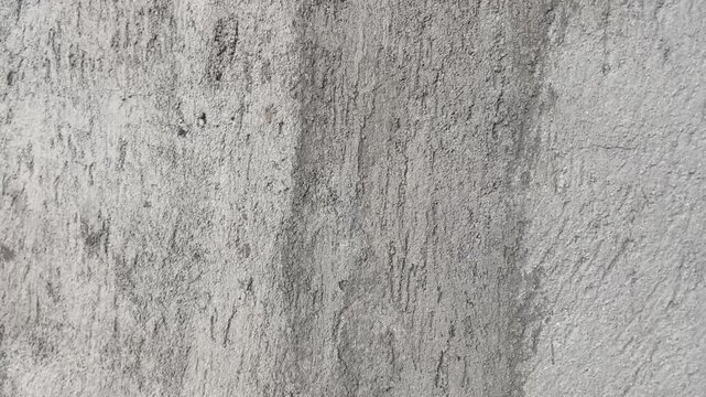 Grey plaster wall with water stains and grunge texture