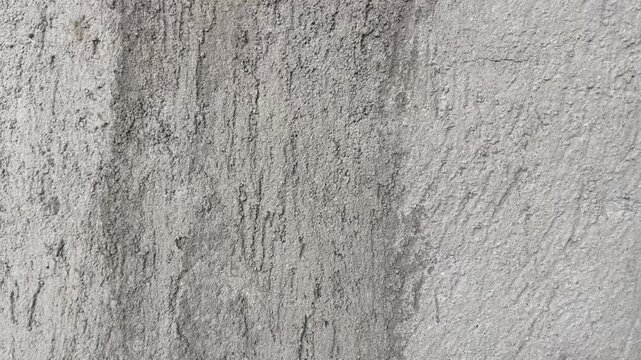 Natural grey stone or cement finish on a rustic building wall