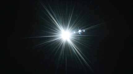 Fototapeta premium A bright glowing white starburst lens flare with subtle optical ring artifacts in the center of a pure dark black background