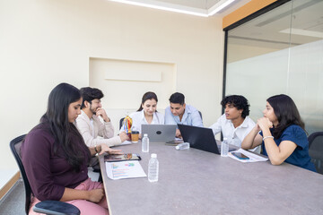 Fototapeta premium Indian business people or office employees sitting in meeting room working together and discuss sales and company growth report, Corporate job. Planning, strategy and Teamwork.