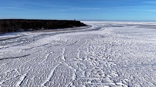 Frozen winter landscape, wide snowy field under clear sky, serene mood