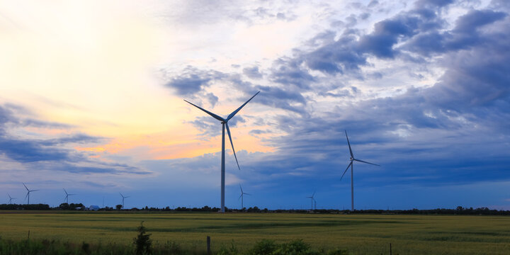 Wind farm generating renewable energy at sunset