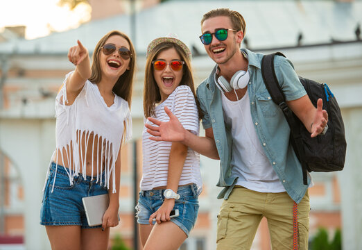 Happy Friends Pointing and Laughing Outdoors.