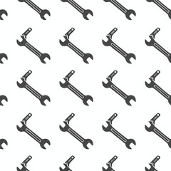 Obraz premium A repeating pattern of dark gray wrenches on a white background