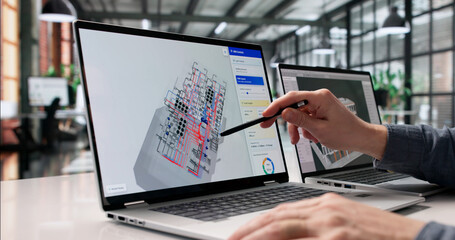 Engineer Diligently Reviews 3D Digital Twin Mapping With Advanced BIM © Andrey Popov