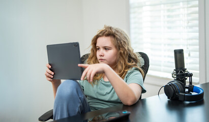 Kid gaming online game. Child gamer playing a game for streaming. Kid playing a video game in home...