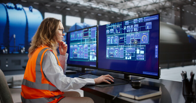 Female Engineer Monitors SCADA System In Oil