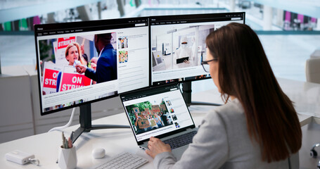 Woman Viewing News On Laptop And Desktop