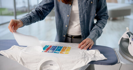 Woman Heat-Pressing Personalized Design Onto T-Shirt
