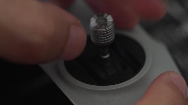 Close Up Shot of Hand Screwing Joystick onto Drone Controller
