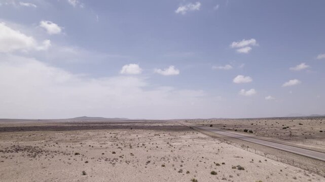 Low aerial shot of a highway in a stark desert landscape, west Texas near the Big Bend