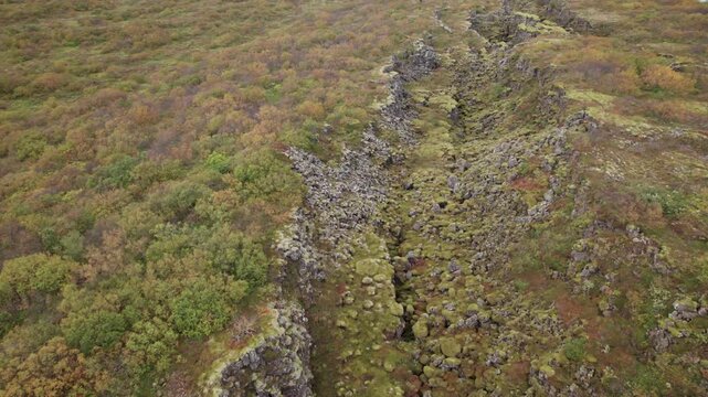 Aerial push in on Hrafnagja Basalt canyon in central Iceland, tectonic plates meeting, fault line