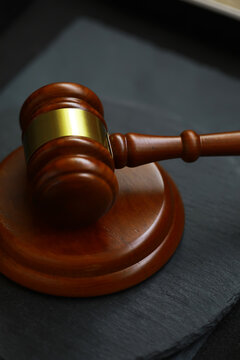 Wooden Gavel on Slate Surface Representing Justice and Legal Proceedings