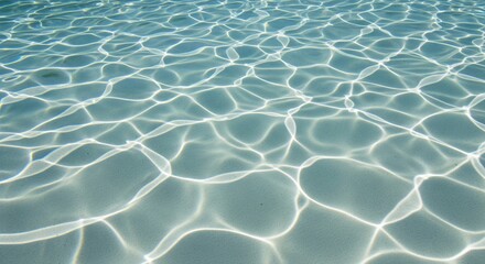 Fototapeta premium Abstract shimmering sunlight patterns on the sandy bottom of a clear blue swimming pool, creating a mesmerizing aquatic texture and tranquil relaxation vibe