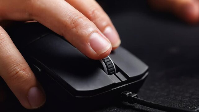 Close-up of hand clicking computer mouse with index finger, slow motion, cinematic lighting, representing digital interaction and modern computing, symbolizing technology use