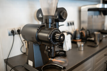 Fototapeta premium Coffee grinder on a kitchen countertop with modern appliances and tools in a contemporary kitchen setting