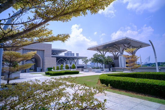 Main Entrance of Tuanku Mizan Zainal Abidin Mosque also known as the Iron Mosque in Putrajaya, Malaysia  viewed from entrance garden featuring modern Islamic architectural arches and metal structure.
